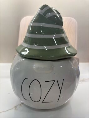 Rae Dunn White Ceramic 'COZY' with Striped Green Hat.